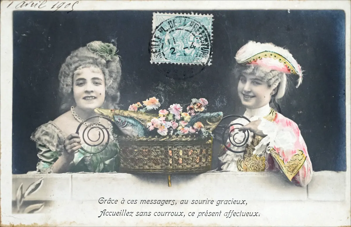 Vintage 1905 French poisson d'avril postcard of two women holding a basket of fish and flowers