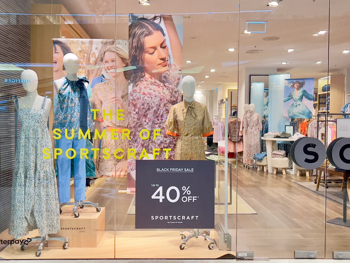 Clothing store window with a Black Friday sale sign offering 40 percent off