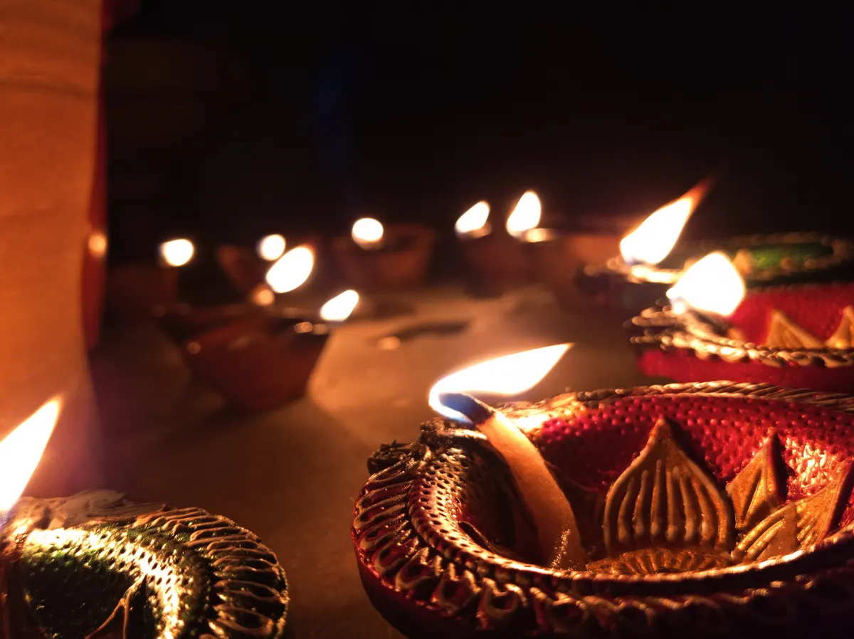 Clay diyas glowing in the dark on Diwali night