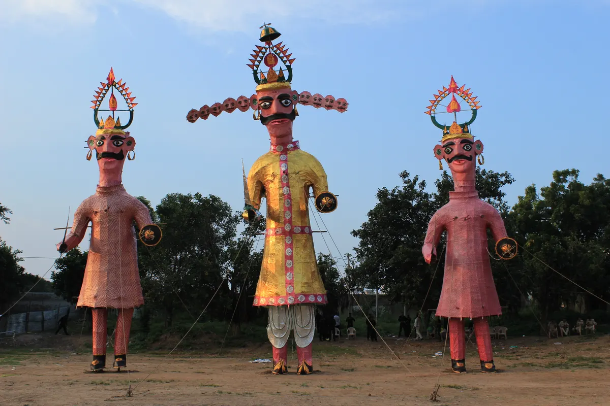 Tall effigies of Ravana, Meghnad and Kumbhakarna standing on a ground before Dussehra