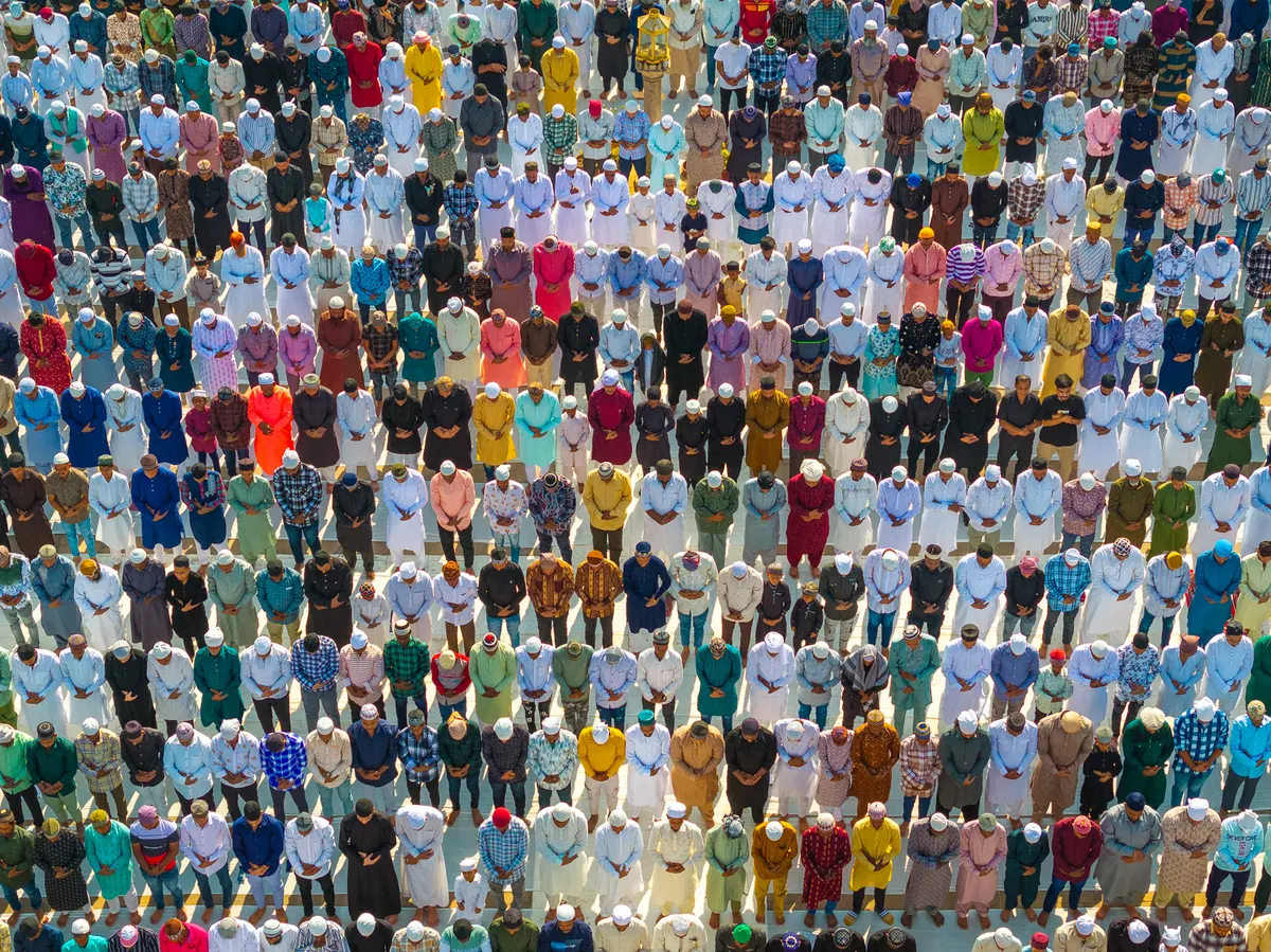 Rows of worshippers standing shoulder to shoulder for Eid prayer