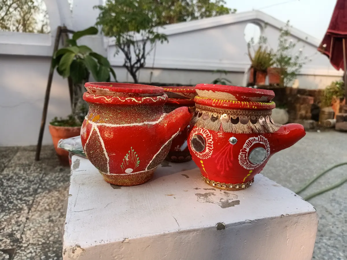 Decorated red clay karwas ready for the Karwa Chauth puja