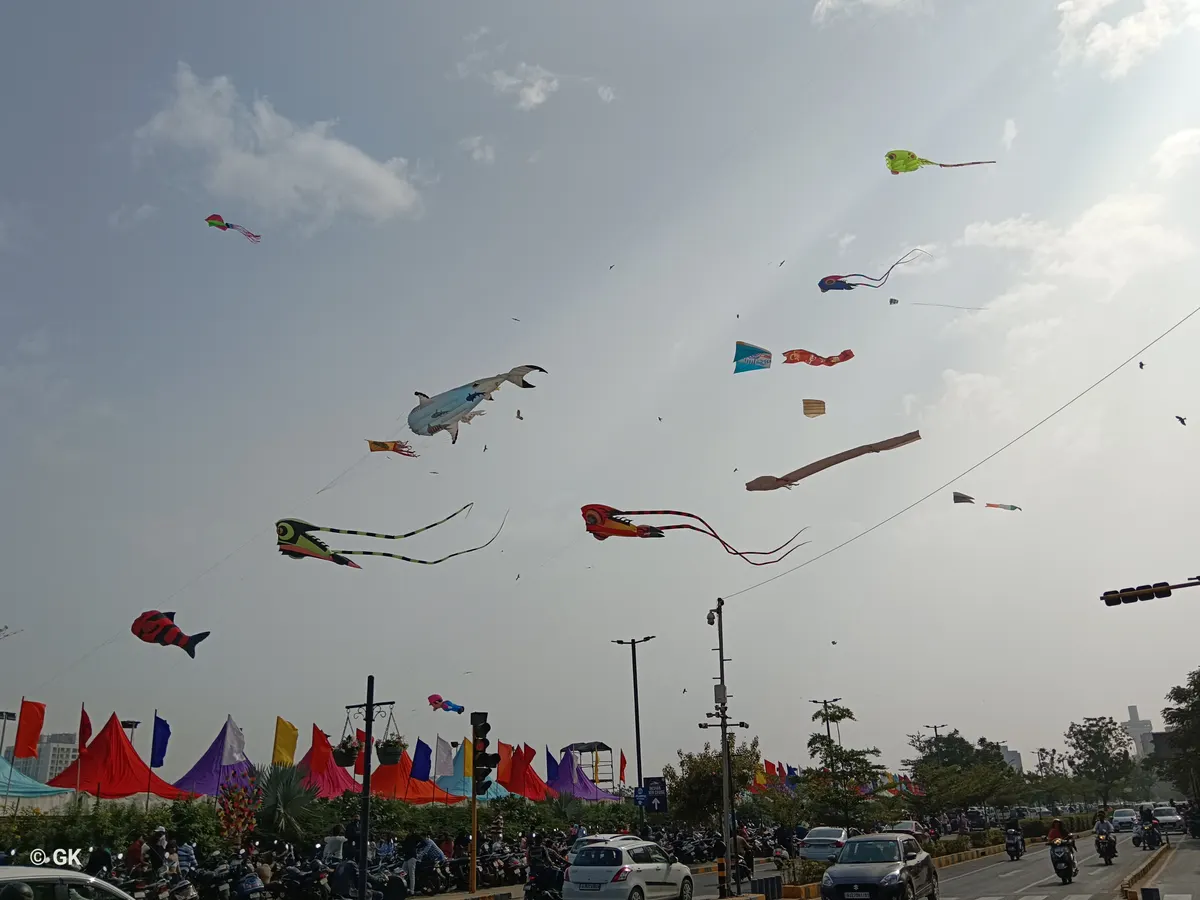 Colourful kites flying over a crowd at the Uttarayan kite festival in Gujarat