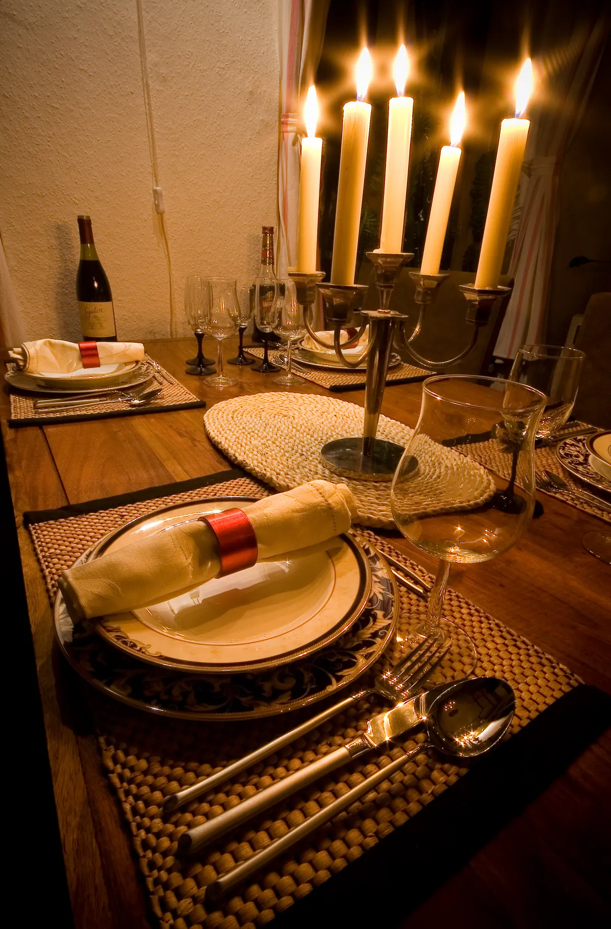 A candlelit dinner table set for a cozy evening at home