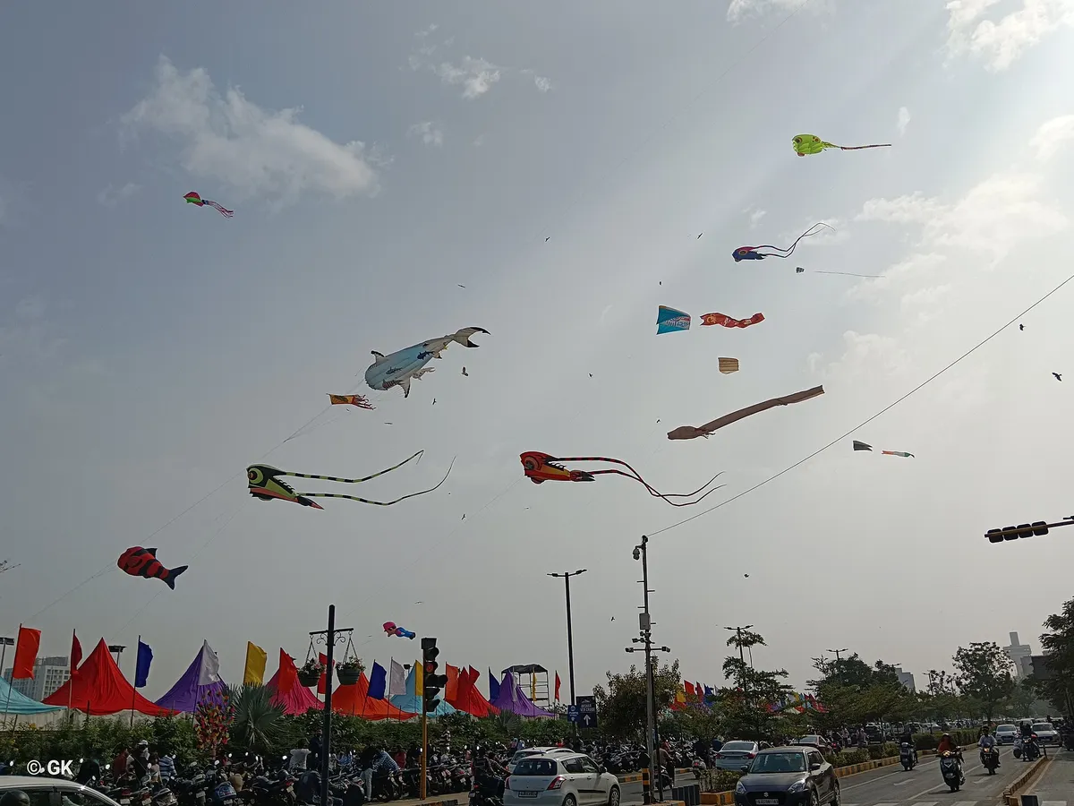 Colourful kites in the sky over a road in Gujarat during the Uttarayan kite festival
