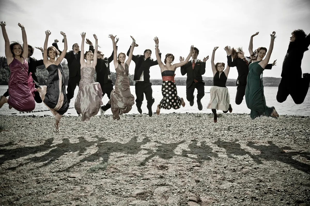 Group of friends jumping together on a beach