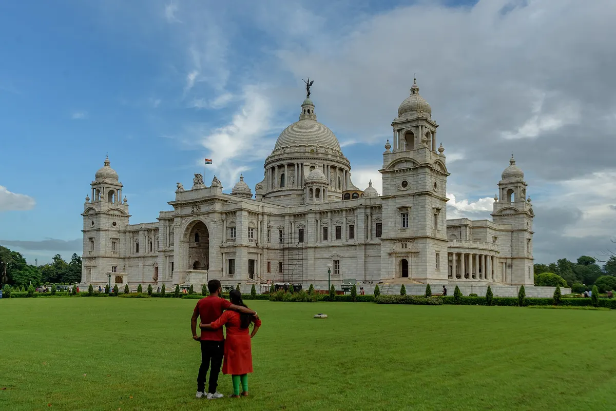 Young couple standing together on the lawn of Victoria Memorial, Kolkata
