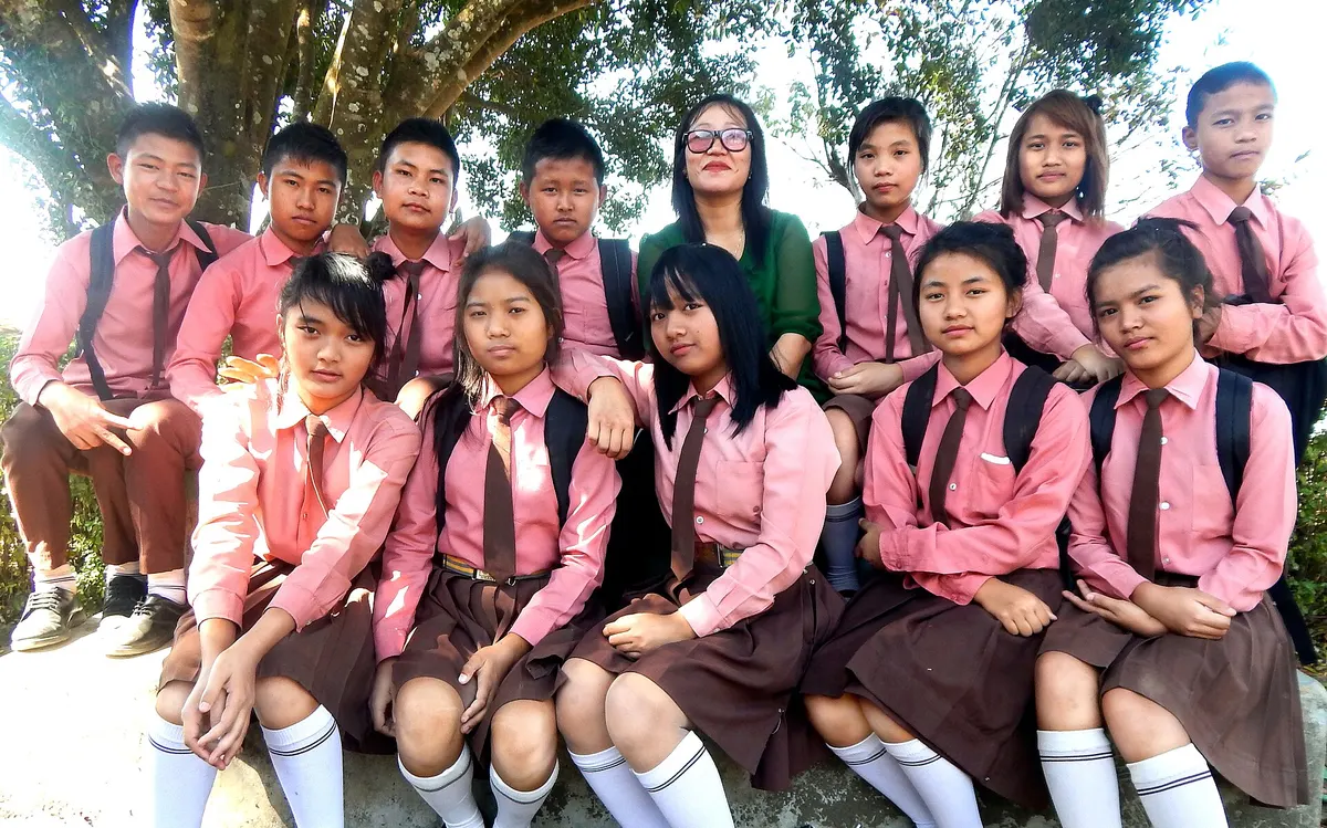 School students in uniform sitting together